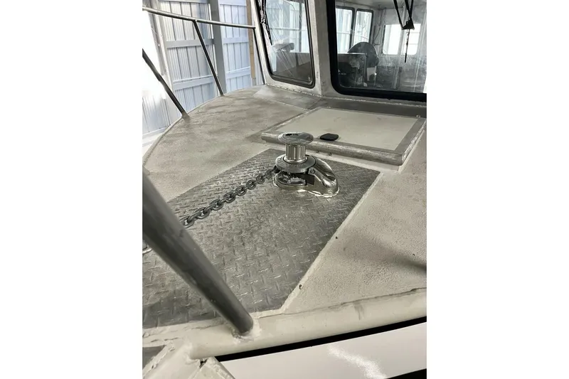 Yacht Photos Pics Rebuilt 1990 custom dive boat with anchor winch on deck, featuring diamond plate flooring.