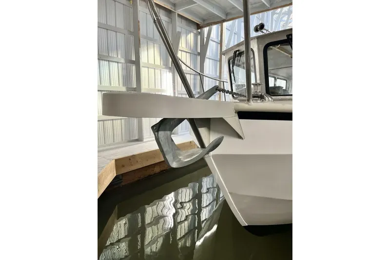  Yacht Photos Pics Custom 1990 rebuilt dive boat with anchor in a covered dock.