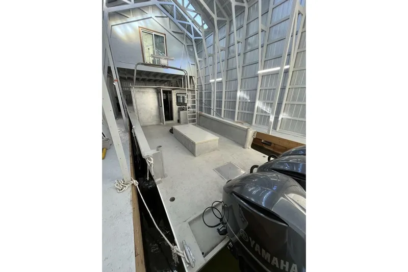  Yacht Photos Pics Custom 1990 rebuilt dive boat/offshore with Yamaha engines in a covered dock.