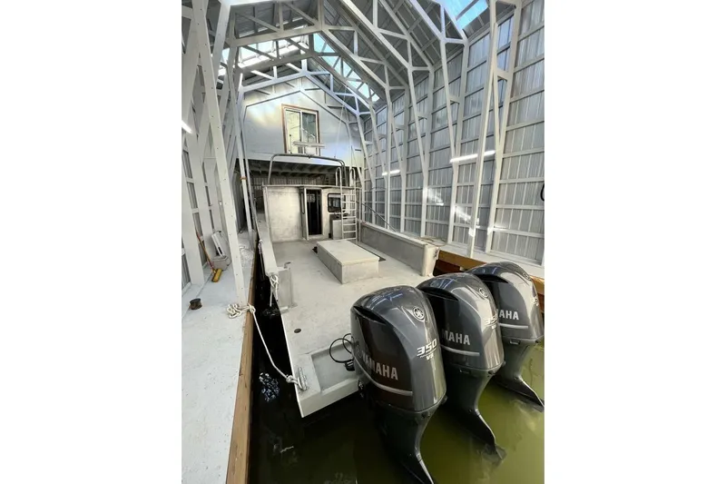  Yacht Photos Pics Custom 1990 rebuilt dive boat with Yamaha engines in covered dock.