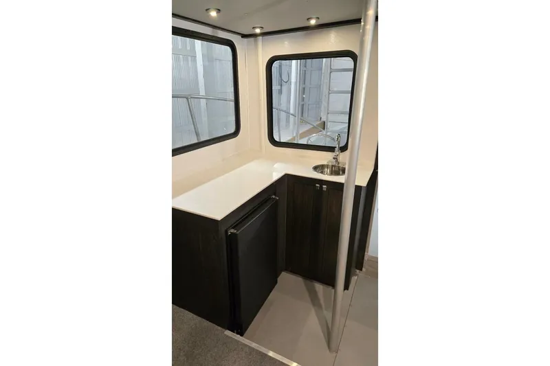  Yacht Photos Pics Interior of 1990 custom rebuilt dive boat with compact kitchenette and windows.