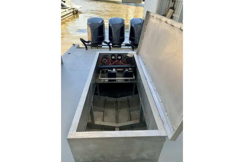  Yacht Photos Pics Open compartment of a 1990 custom rebuilt dive boat with visible engines.