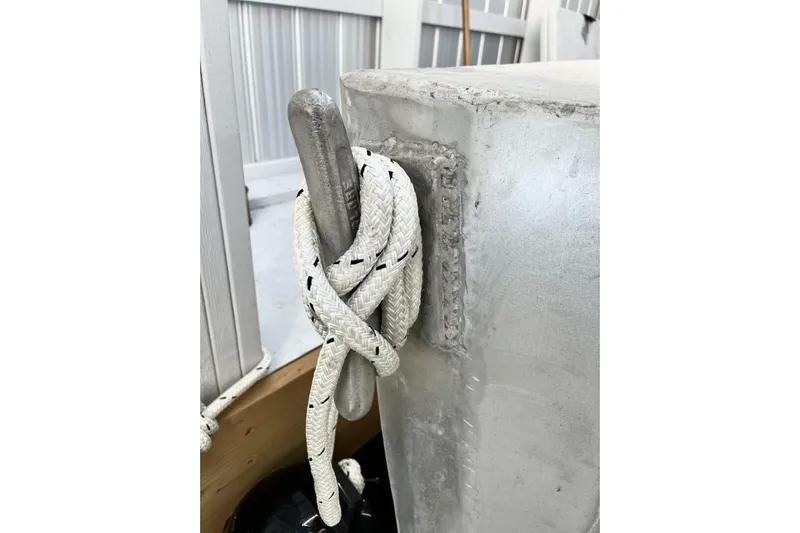  Yacht Photos Pics White rope tied around metal cleat on 1990 custom rebuilt dive boat.