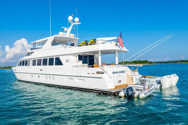 Done Deal Yacht Photos Pics Luxury 2010 Hargrave Raised Pilothouse yacht on serene blue waters, featuring sleek design and American flag.