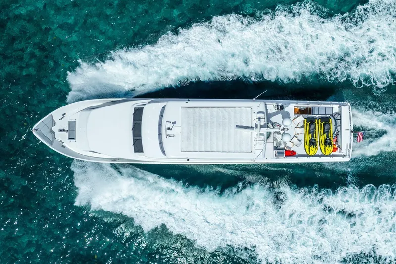 Done Deal Yacht Photos Pics Aerial view of 2010 Hargrave Raised Pilothouse yacht cruising on turquoise water.