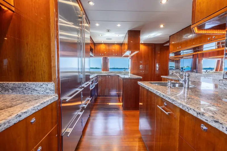 Done Deal Yacht Photos Pics Luxurious 2010 Hargrave Raised Pilothouse yacht kitchen with granite countertops and wooden cabinetry.