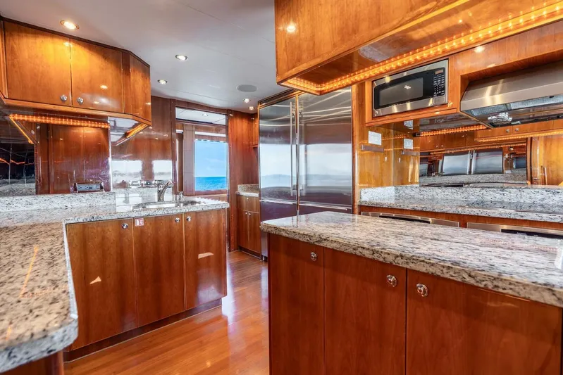 Done Deal Yacht Photos Pics Luxurious 2010 Hargrave Raised Pilothouse yacht kitchen with granite countertops and wood cabinetry.