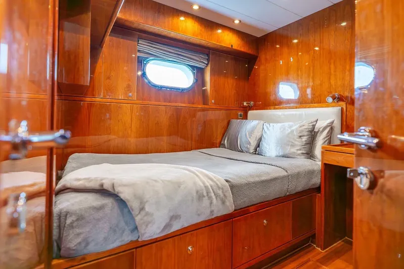 Done Deal Yacht Photos Pics Luxurious cabin interior of 2010 Hargrave Raised Pilothouse yacht with wood paneling and cozy bed.