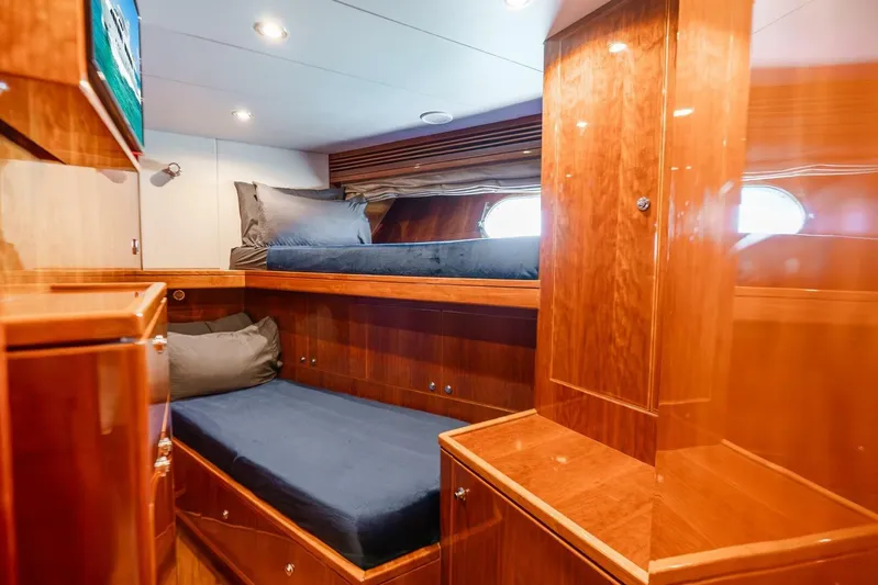 Done Deal Yacht Photos Pics Luxurious 2010 Hargrave Raised Pilothouse yacht cabin with wooden interior and cozy bedding.