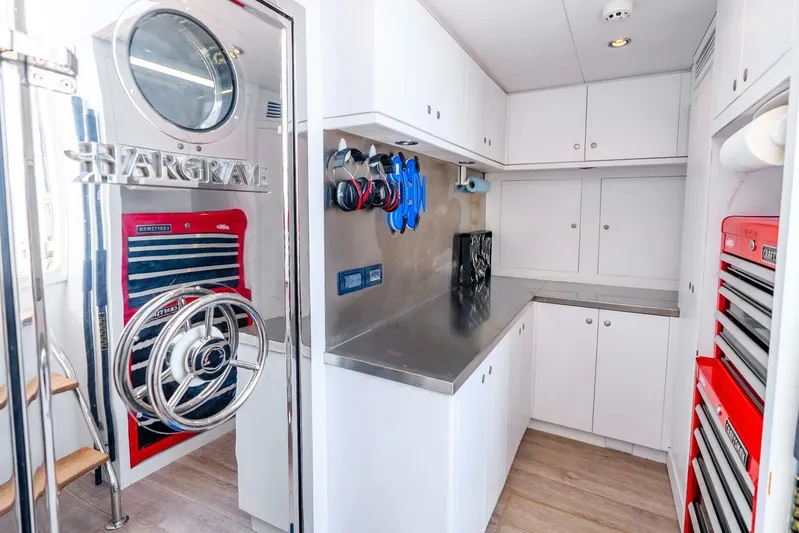 Done Deal Yacht Photos Pics 2010 Hargrave Raised Pilothouse yacht interior with stainless steel counters and red tool cabinets.