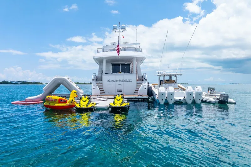 Done Deal Yacht Photos Pics Luxury 2010 Hargrave Raised Pilothouse yacht with water toys and slide in a serene ocean setting.