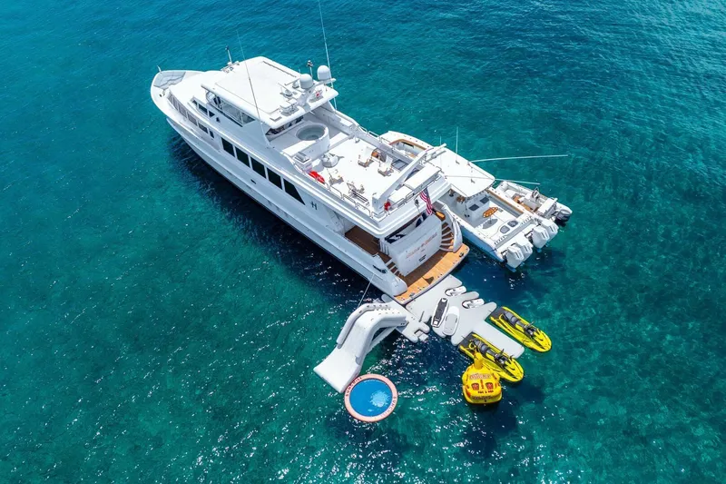 Done Deal Yacht Photos Pics Aerial view of 2010 Hargrave Raised Pilothouse yacht with water toys in clear ocean.