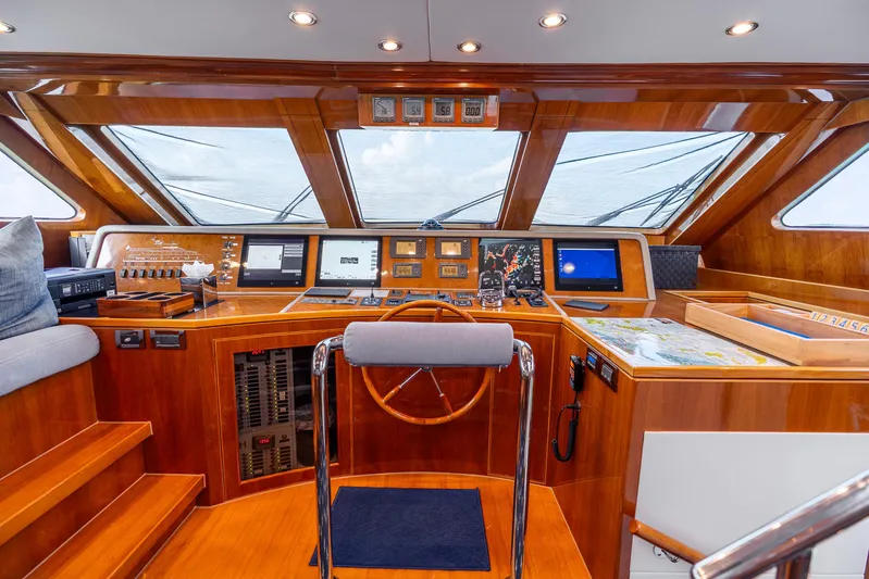Done Deal Yacht Photos Pics Luxurious 2010 Hargrave Raised Pilothouse yacht interior with navigation equipment and wooden finishes.