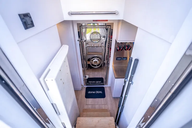 Done Deal Yacht Photos Pics Stairway leading to Hargrave Raised Pilothouse interior, featuring polished door and nautical decor.