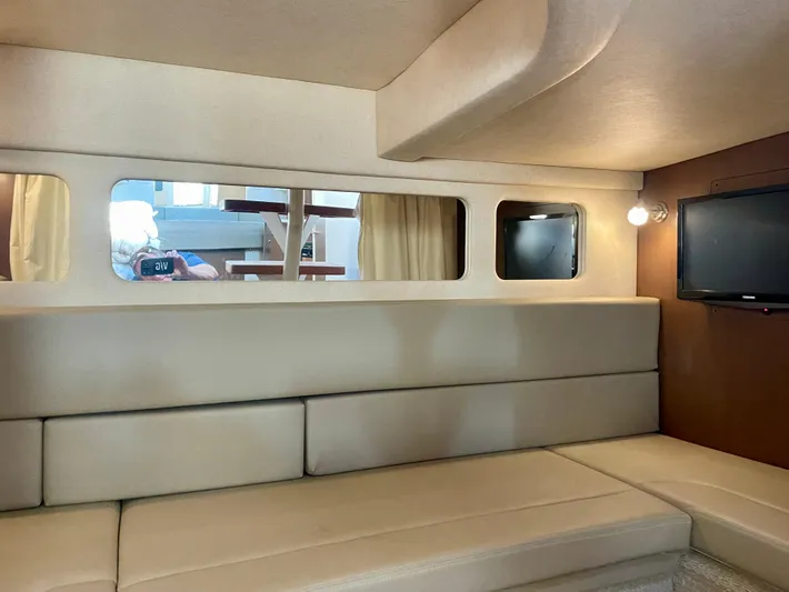 Ilaria Yacht Photos Pics Interior of 2014 Sea Ray 330 Sundancer yacht with beige seating and wall-mounted TV.