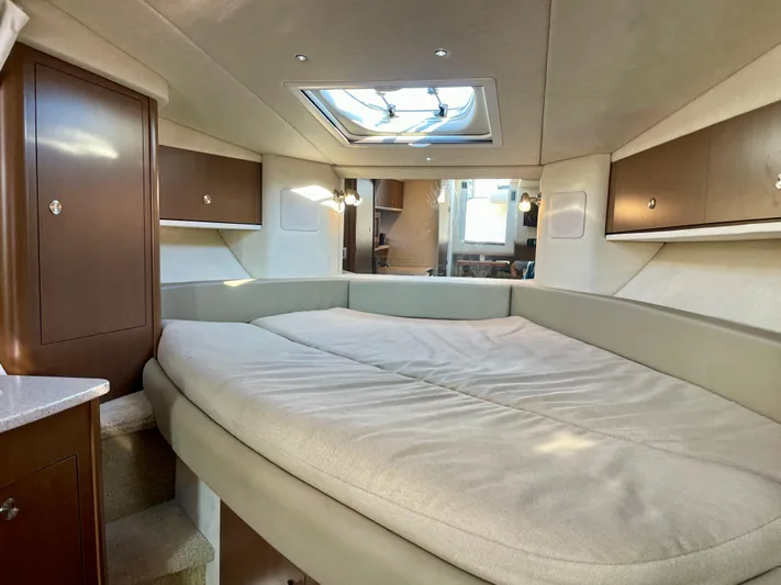 Ilaria Yacht Photos Pics Interior cabin of 2014 Sea Ray 330 Sundancer with skylight and cozy bed.