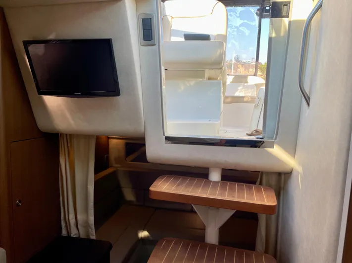 Ilaria Yacht Photos Pics Interior of 2014 Sea Ray 330 Sundancer with TV and wooden steps.