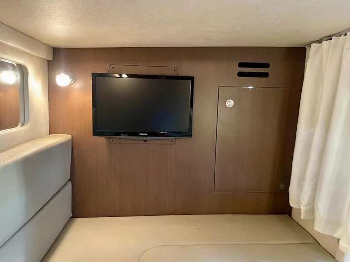 Ilaria Yacht Photos Pics Interior of 2014 Sea Ray 330 Sundancer with mounted TV and cozy seating area.