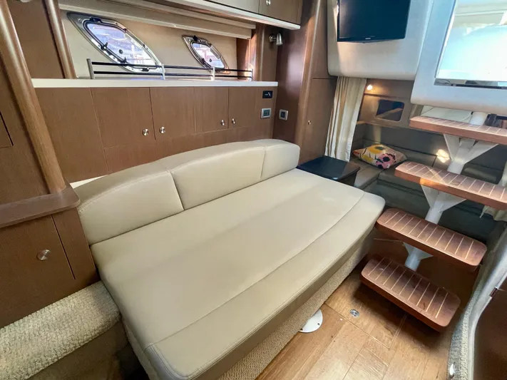 Ilaria Yacht Photos Pics Interior of 2014 Sea Ray 330 Sundancer with beige seating and wooden accents.
