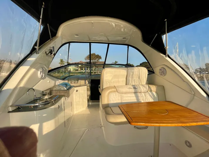 Ilaria Yacht Photos Pics Interior of 2014 Sea Ray 330 Sundancer yacht with seating and table.