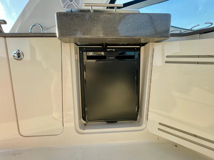 Ilaria Yacht Photos Pics 2014 Sea Ray 330 Sundancer boat kitchenette with compact fridge and sink.