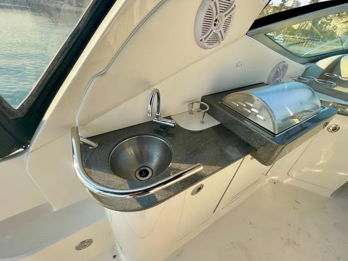 Ilaria Yacht Photos Pics 2014 Sea Ray 330 Sundancer yacht kitchenette with sink and covered grill.