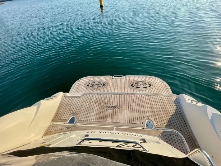 Ilaria Yacht Photos Pics 2014 Sea Ray 330 Sundancer boat stern with teak deck on calm water.