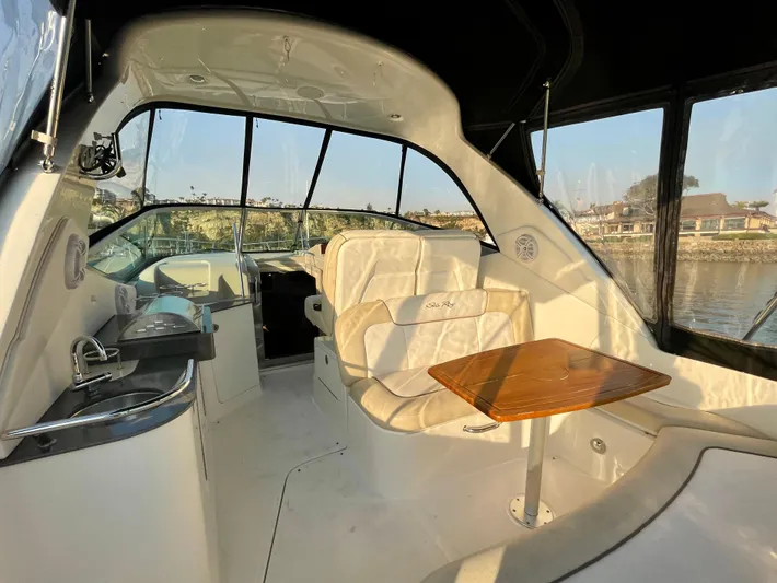 Ilaria Yacht Photos Pics Interior of 2014 Sea Ray 330 Sundancer yacht with seating and table.
