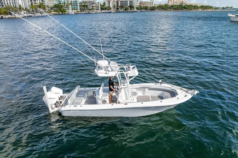  Yacht Photos Pics 2021 Yellowfin 26 Hybrid boat on water, featuring dual Mercury engines.