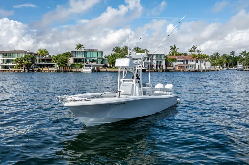  Yacht Photos Pics 2021 Yellowfin 26 Hybrid boat on water near luxury waterfront homes.