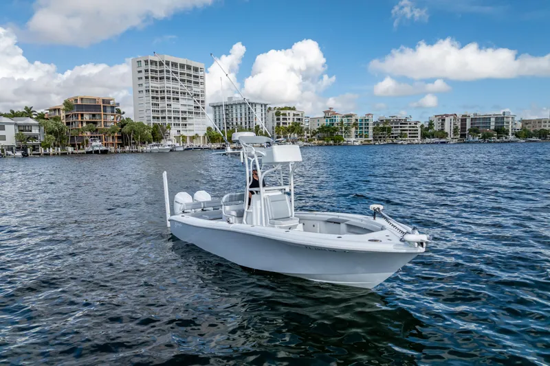  Yacht Photos Pics 2021 Yellowfin 26 Hybrid boat on water with cityscape background.
