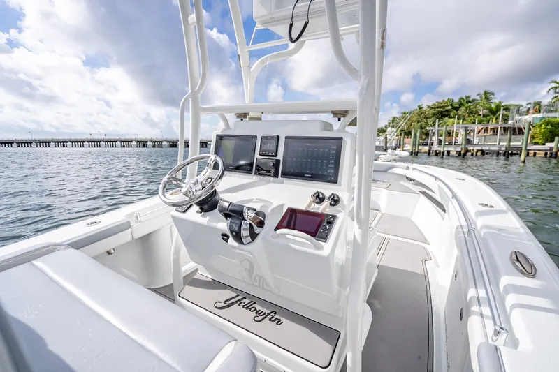  Yacht Photos Pics 2021 Yellowfin 26 Hybrid boat interior with modern dashboard and steering, docked by the water.