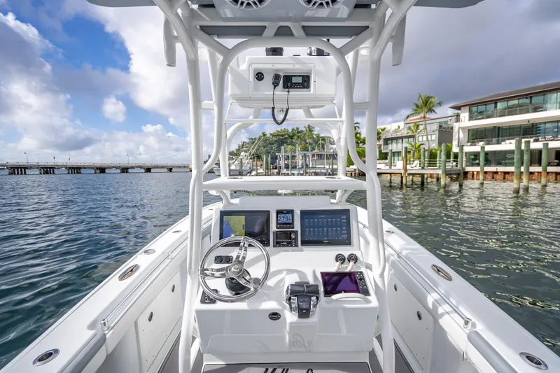  Yacht Photos Pics 2021 Yellowfin 26 Hybrid boat interior with modern dashboard and steering, dockside view.