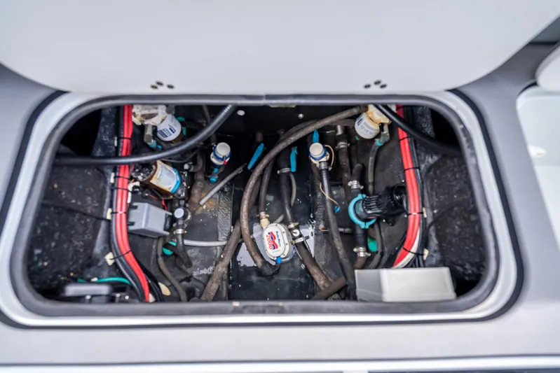  Yacht Photos Pics 2021 Yellowfin 26 Hybrid boat compartment with wiring and plumbing components.