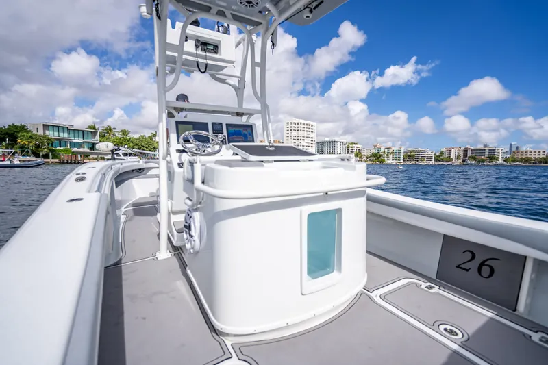  Yacht Photos Pics 2021 Yellowfin 26 Hybrid boat on water, featuring sleek design and modern controls.