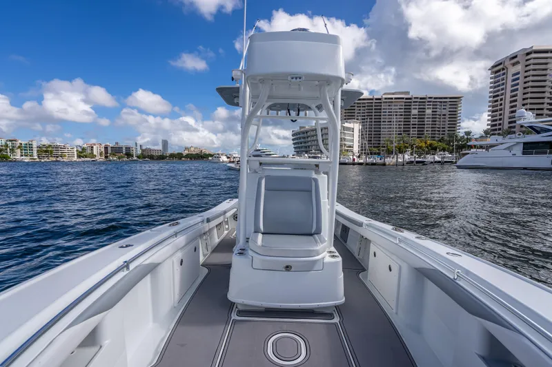  Yacht Photos Pics 2021 Yellowfin 26 Hybrid boat on water with city skyline and marina backdrop.