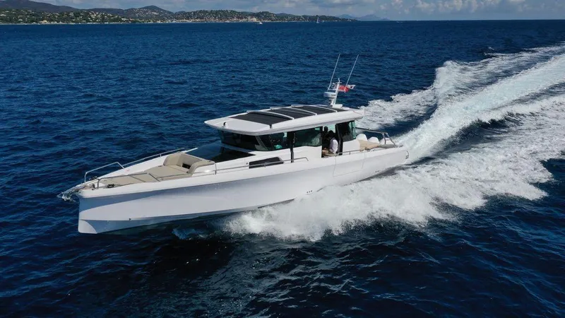  Yacht Photos Pics 2023 Axopar 45 Cross Cabine cruising on open blue sea.