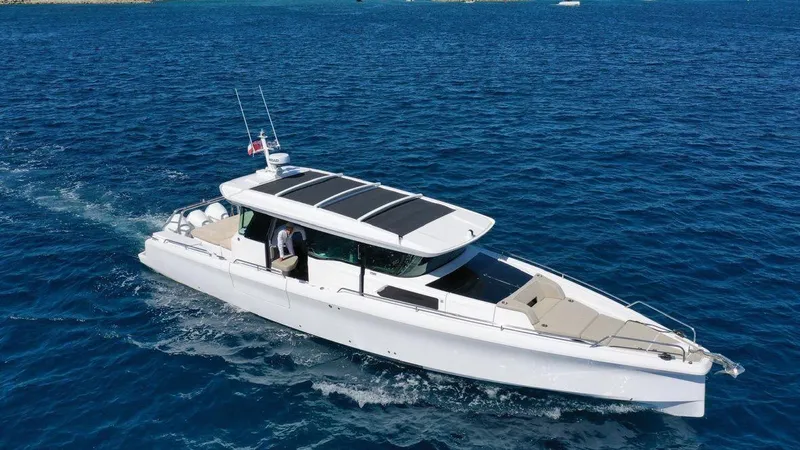  Yacht Photos Pics 2023 Axopar 45 Cross Cabin cruising on open blue water.