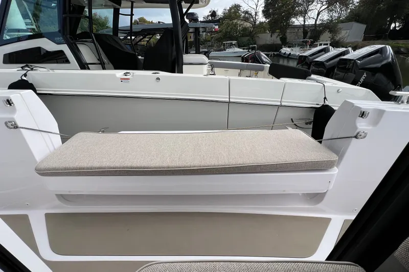  Yacht Photos Pics 2023 Axopar 45 Cross Cabine boat interior with cushioned seating and modern design.