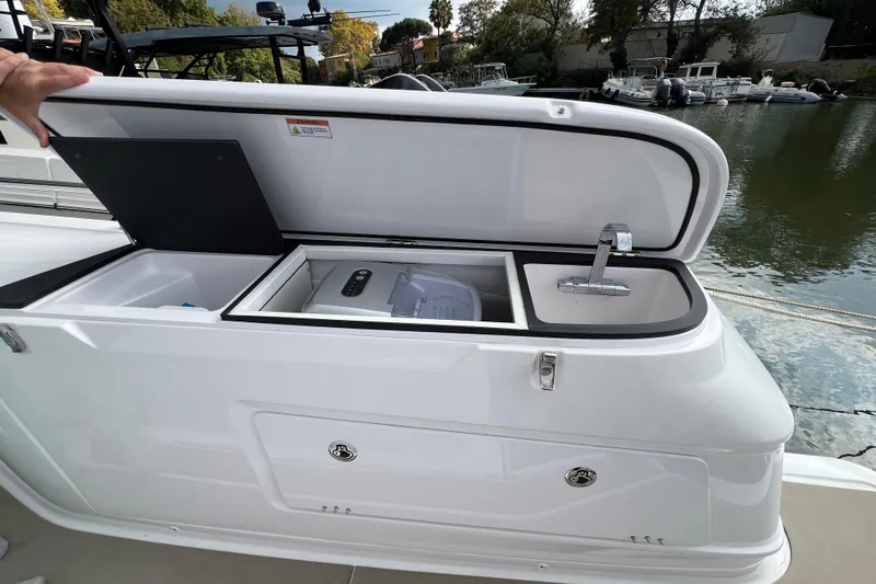  Yacht Photos Pics 2023 Axopar 45 Cross Cabine boat with open storage compartment and sink.