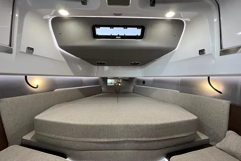  Yacht Photos Pics 2023 Axopar 45 Cross Cabine interior with spacious gray seating and modern lighting.
