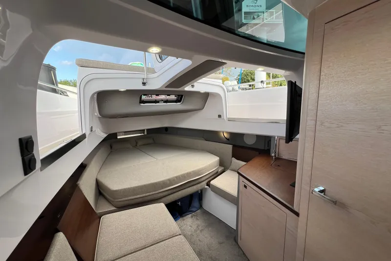  Yacht Photos Pics 2023 Axopar 45 Cross Cabine interior with cozy seating and modern design.