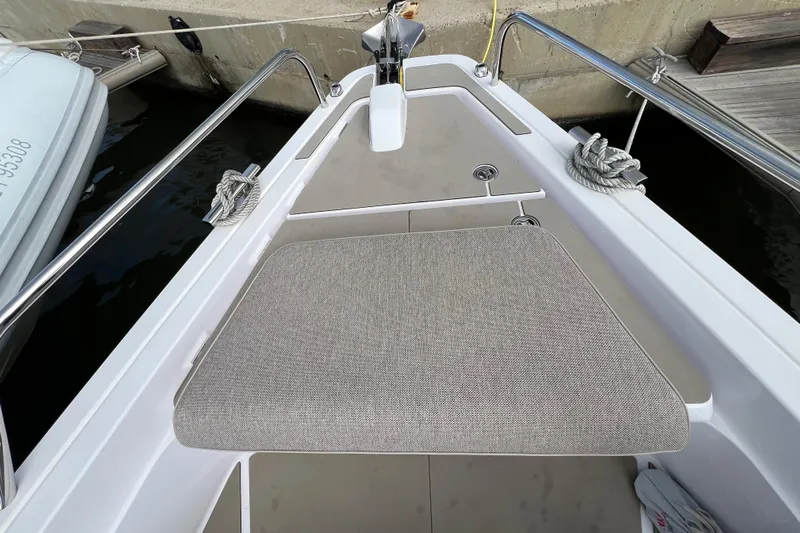  Yacht Photos Pics Bow seating area of 2023 Axopar 45 Cross Cabine, featuring sleek design and mooring ropes.