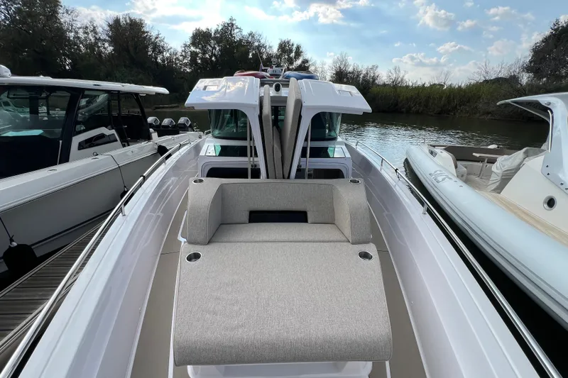  Yacht Photos Pics 2023 Axopar 45 Cross Cabin boat with sleek design and comfortable seating.