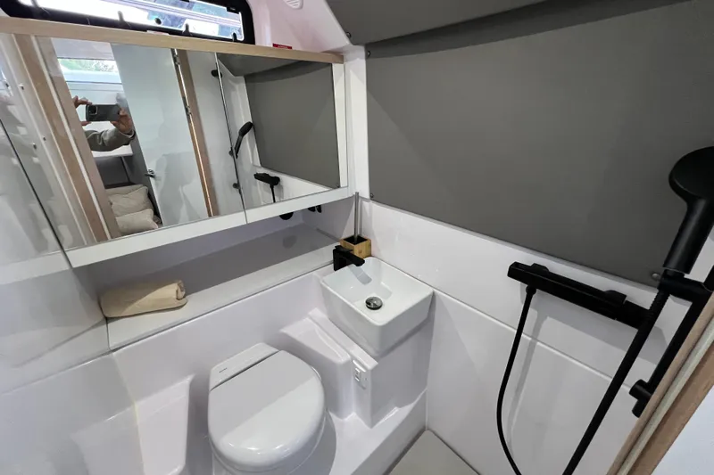  Yacht Photos Pics 2023 Axopar 45 Cross Cabine bathroom with modern fixtures and sleek design.