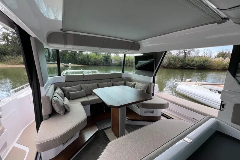  Yacht Photos Pics Luxurious interior of 2023 Axopar 45 Cross Cabine with plush seating and scenic water view.