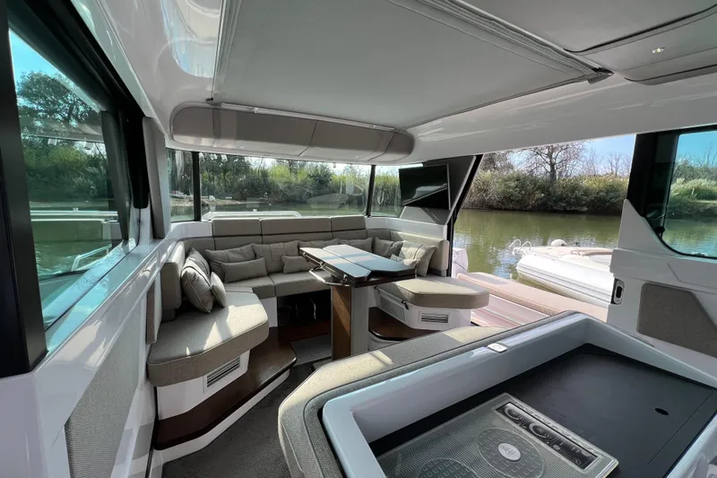  Yacht Photos Pics Luxurious interior of 2023 Axopar 45 Cross Cabine with plush seating and scenic views.