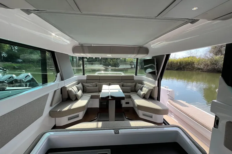  Yacht Photos Pics Luxurious interior of 2023 Axopar 45 Cross Cabin with comfortable seating and scenic water view.