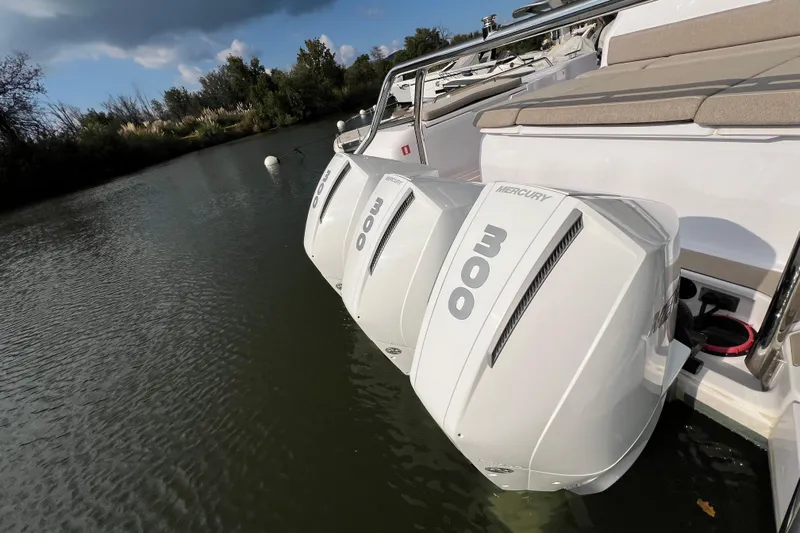  Yacht Photos Pics 2023 Axopar 45 Cross Cabine with triple Mercury 300 engines on a calm river.