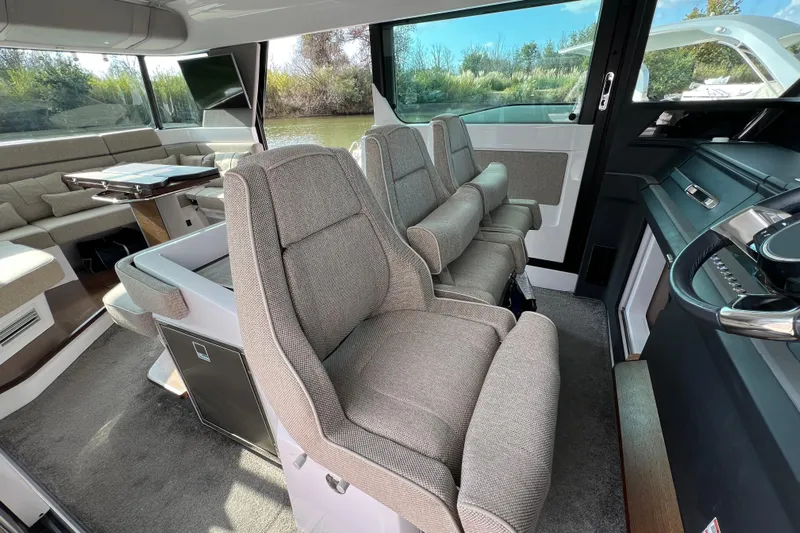  Yacht Photos Pics Luxurious interior of 2023 Axopar 45 Cross Cabine with plush seating and modern design.